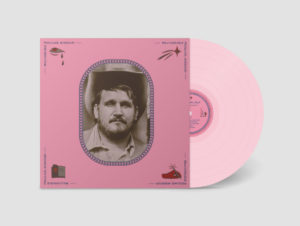 Image: Album cover and CD, both pink. In the center of the album cover is a sepia photograph of a white man from the shoulder up. He has dark hair and a short beard, and is wearing a cowboy hat and collared button-down shirt. In each corner of the album are graphic symbols like a hand with a pen and a crying eye.